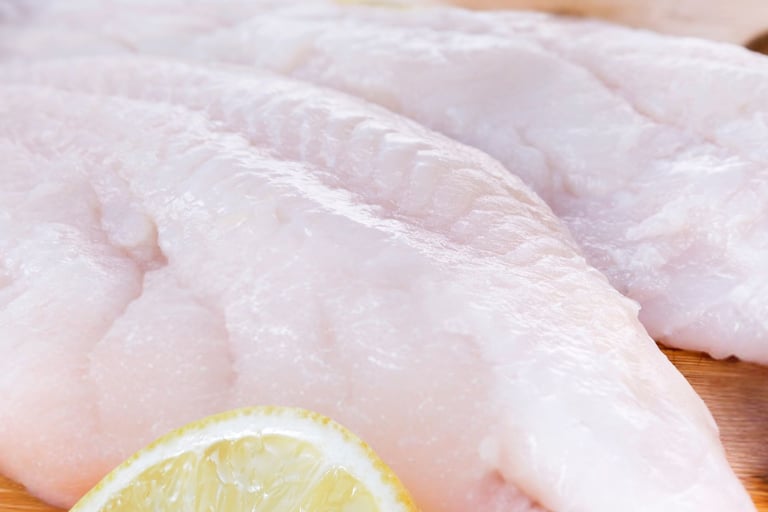 a piece of fish fillet with a slice of lemon