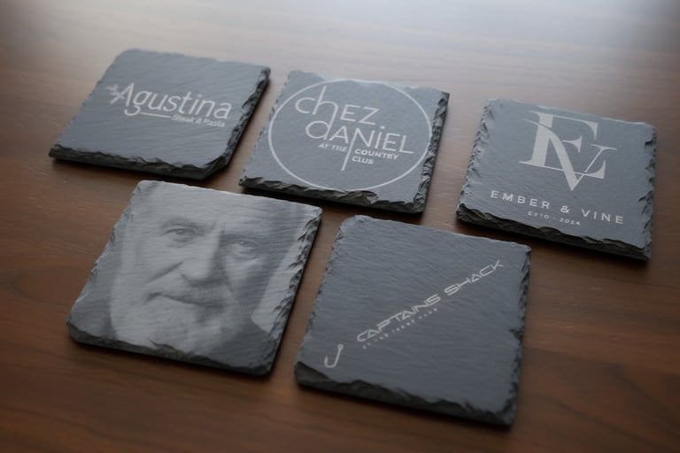 Various restaurant logos and a face in slate rock engaved