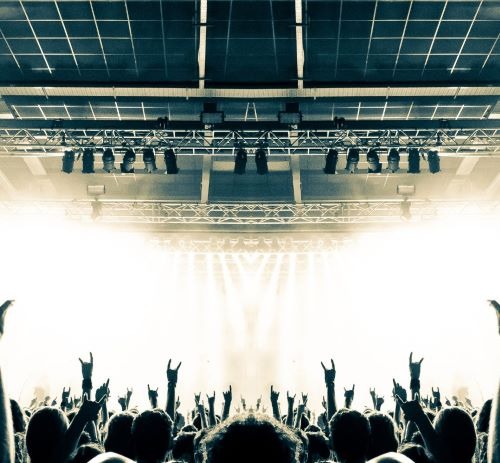 a crowd of people standing in front of a stage