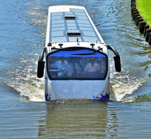 a bus is driving through the water