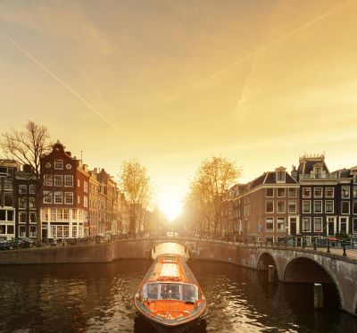 a boat on a river with a bridge in the background