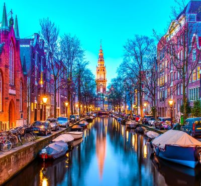 Amsterdam - a canal with boats and buildings in the background