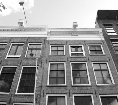 a black and white photo of a building with windows