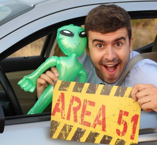 a man holding a sign that says area 51