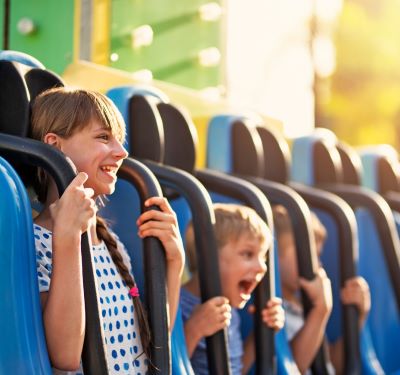 a group of children's riding on a roller coaster