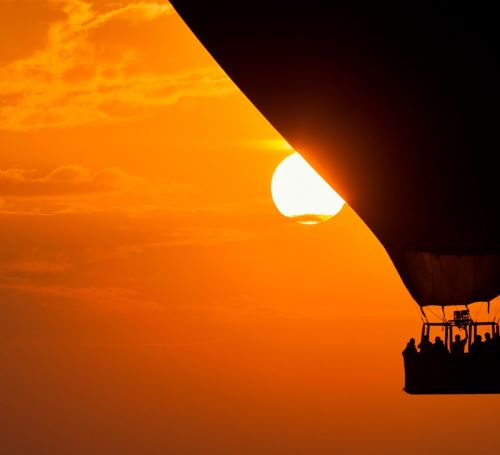 a hot air balloon in the sky with people in a hot air balloon