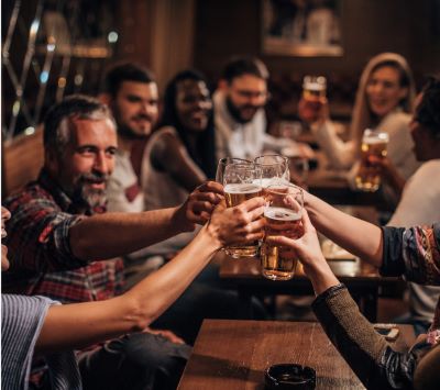 a group of people holding hands up in a toast