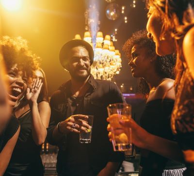 a group of people standing around a bar