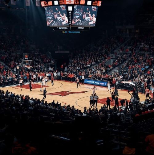 a basketball game with a crowd of people watching a game