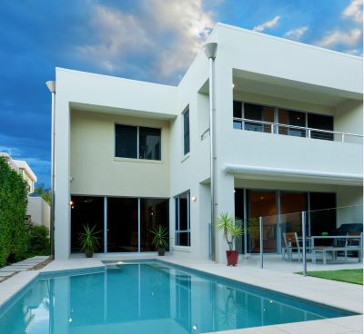 a house with a pool and a pool in the background
