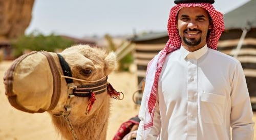 a man in a white shirt and a camell