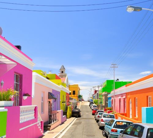 a street scene with cars parked on the side of the road