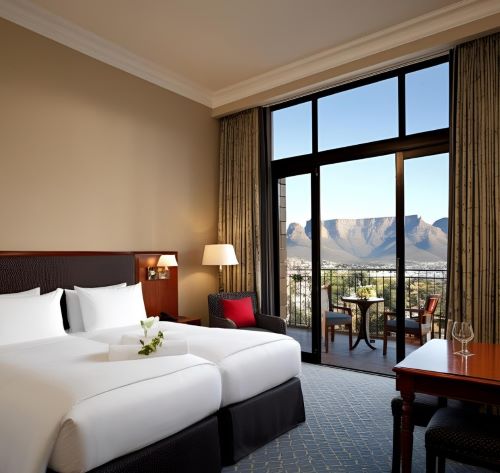 a hotel room with a view of a mountain
