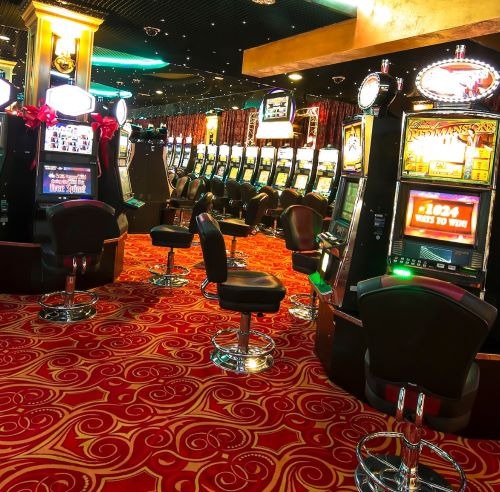 a casino room with a lot of casino machines