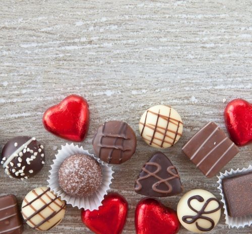 a variety of chocolates and chocolates on a wooden table
