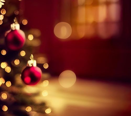 a christmas tree with red ornaments and a christmas tree