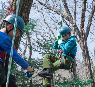 a boy and girl on a zip line