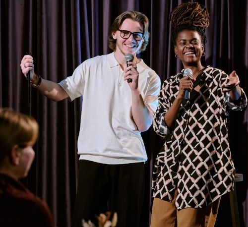 Two comedians performing in a theater