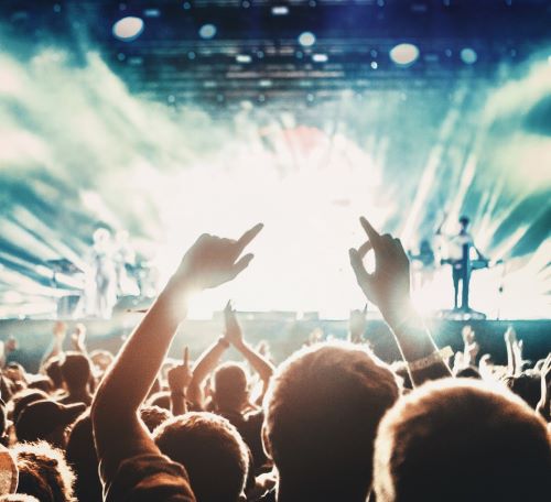 a crowd of people standing in front of a stage with a stage and a stage