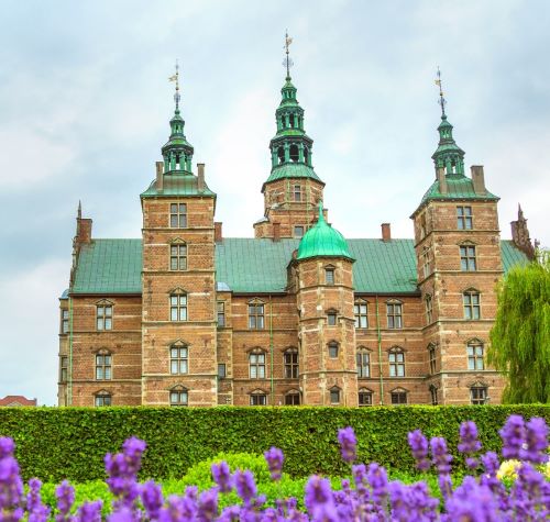 a castle like building with a green roof and a green roof