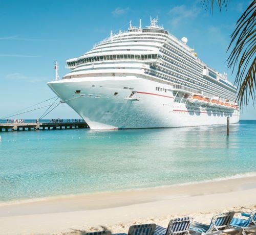 a cruise ship docked at a beach
