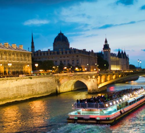 a boat on the river with a bridge in the background