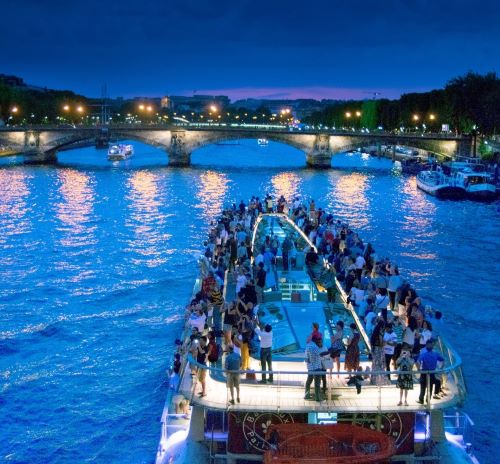 a boat with people on it in the middle of a river