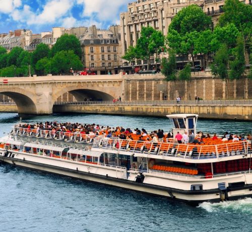a boat with people on it in the middle of a river