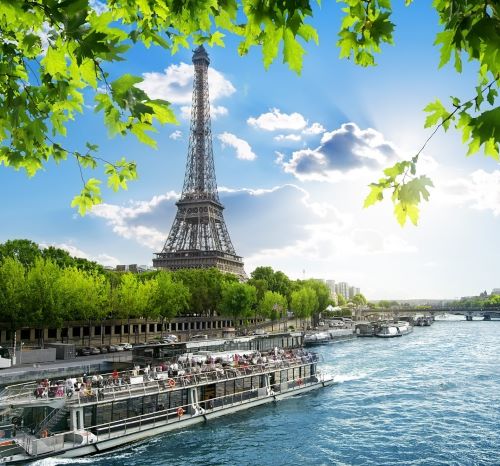 a boat on the river with a view of the eiffel tower