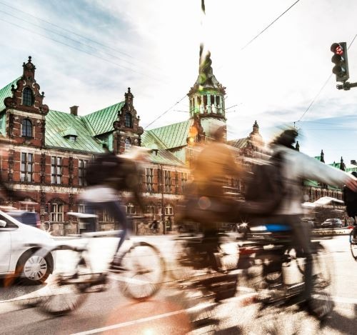 a group of people riding bikes down a street