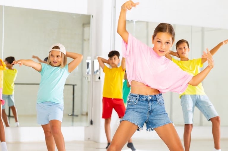 a group of young people dancing in a dance class
