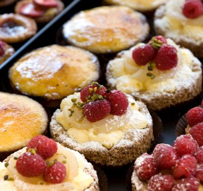 a tray of pastries with raspberry pies