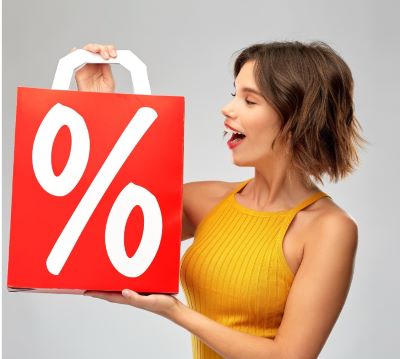 a woman holding a red gift bag with a percent sign
