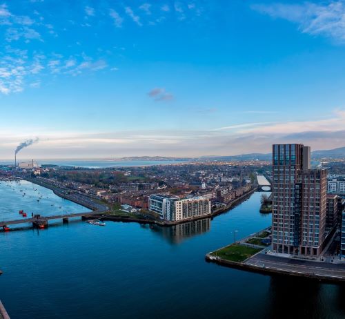 a river with a bridge and a city in the background