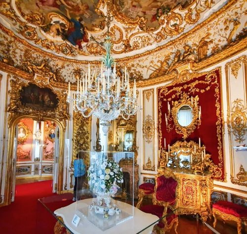 a room in a castle with a chandelier and a chandelier