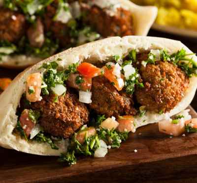 a meatball pita filled with vegetables and meatballs