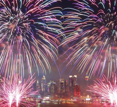 fireworks in the sky over a city skyline