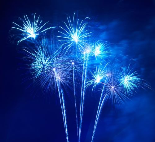 a bunch of fireworks in a blue sky
