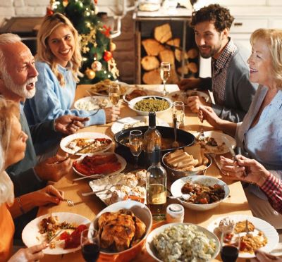 a group of people sitting around a table with food