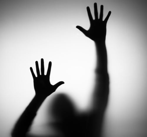 a person's hand is reaching up to a person's hand