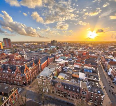 groningen -a cityscape of a city with a sunset