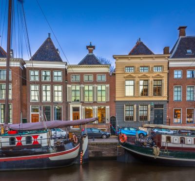 groningen - a boat is docked in a harbor with a boat in the water