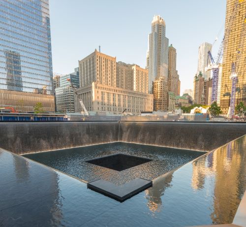 a square shaped fountain with a square shaped object in the middle