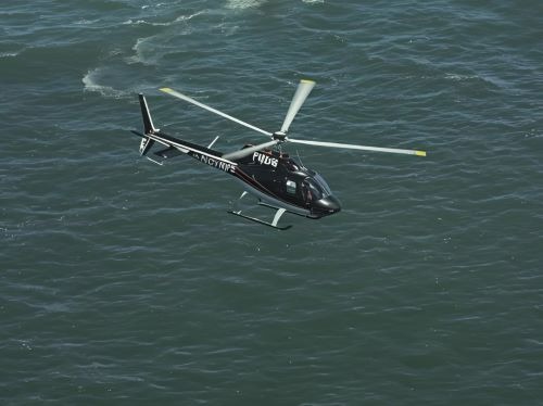 a helicopter flying over a body of water