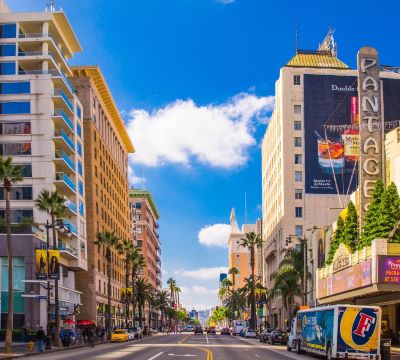 hollywood - a city street with a bus and cars parked on the side of the road