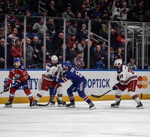 a group of people playing a game of hockey