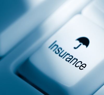 insurance - computer keyboard with a black umbrella on it