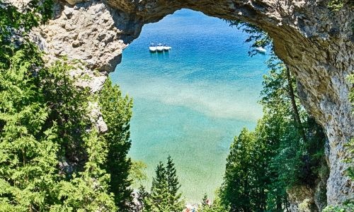 a boat is seen through a window of a cave