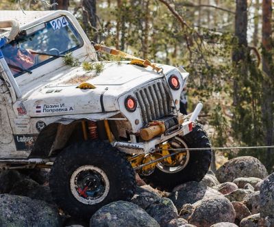 a jeep wrangling a jeep with a man in the background