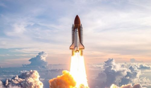 a space shuttle rocket ship launching into the sky